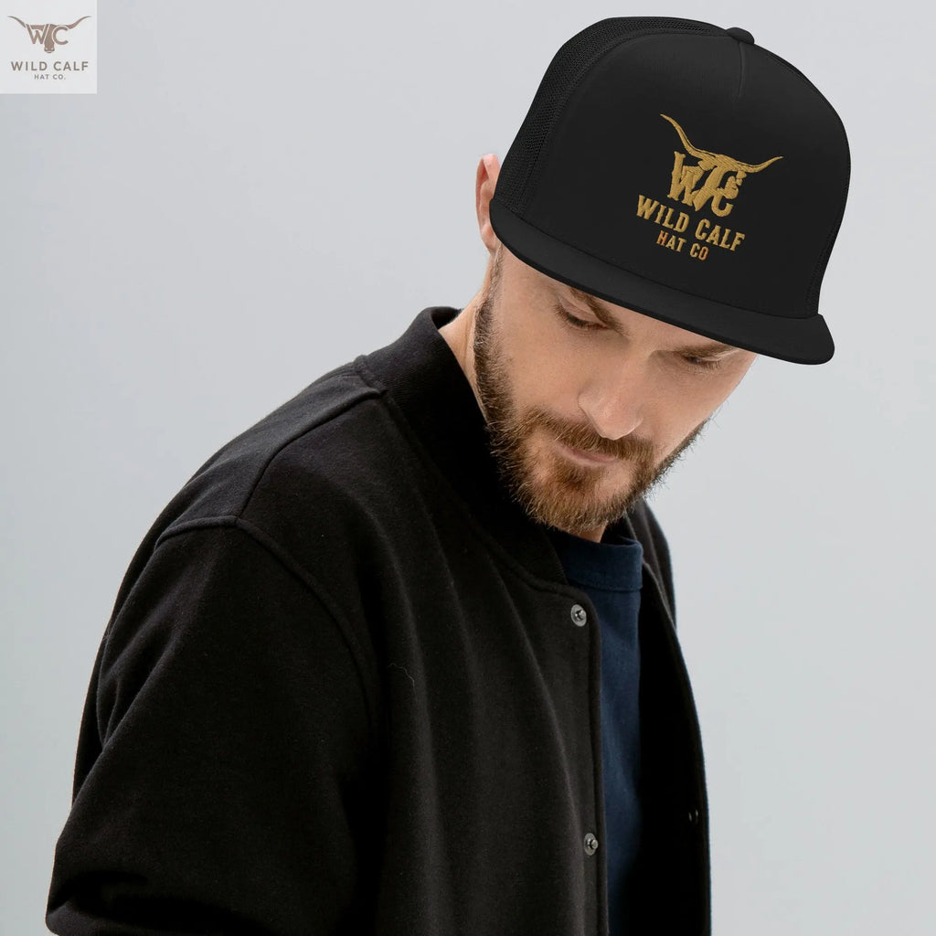 Man wearing a black 5-panel trucker cap with gold western logo, modern professional style