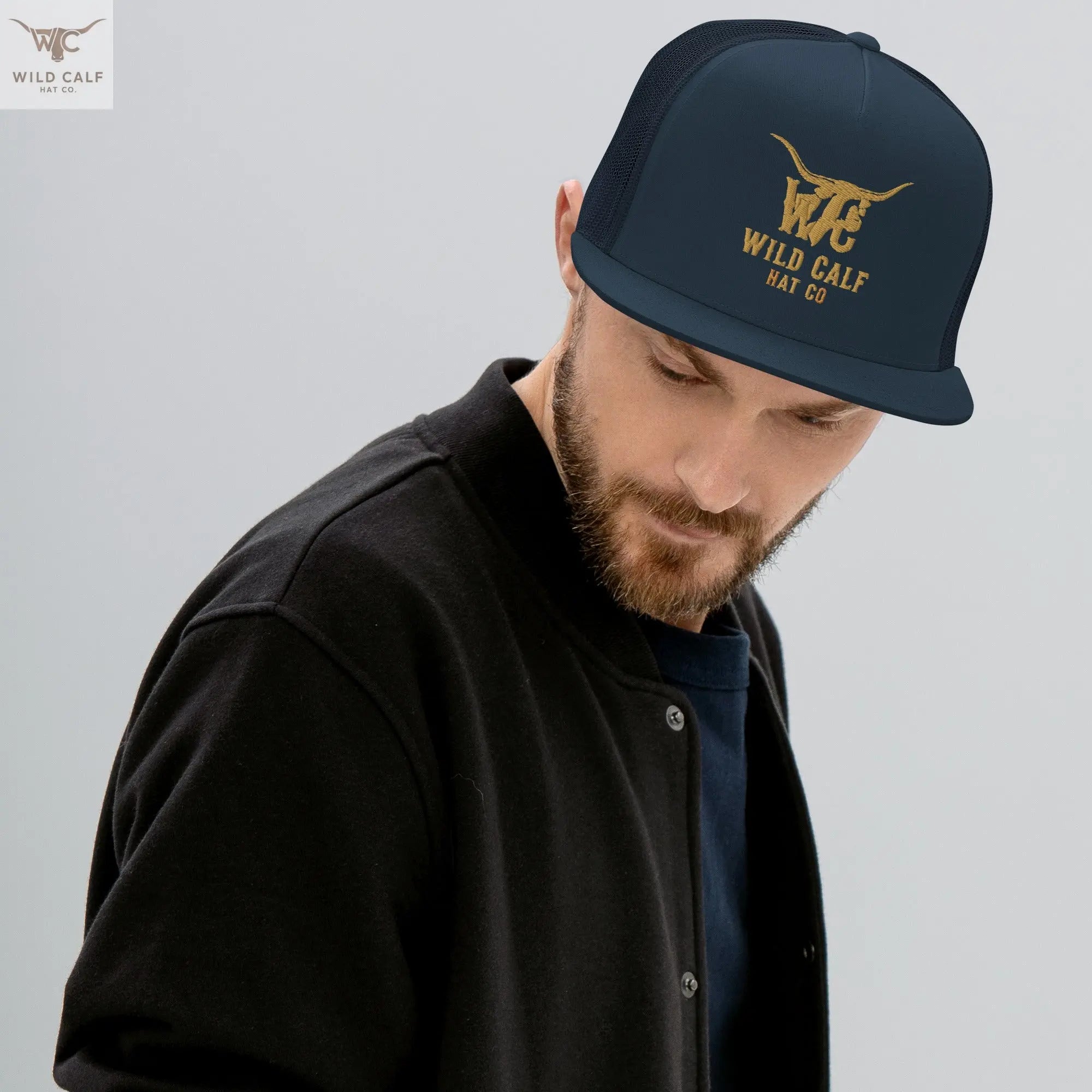 Man wearing navy western trucker cap with gold embroidery, professional casual style