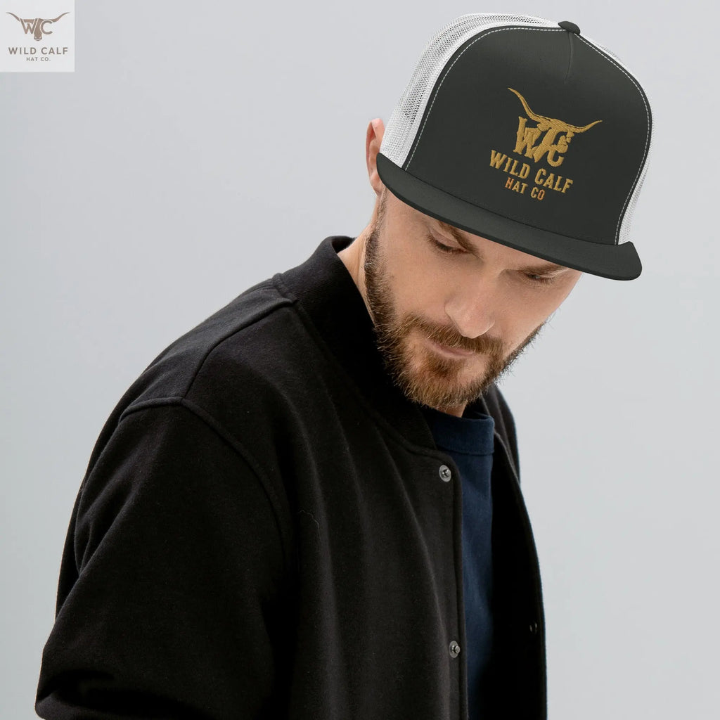 Western charcoal and white trucker cap with gold embroidered logo, worn professionally