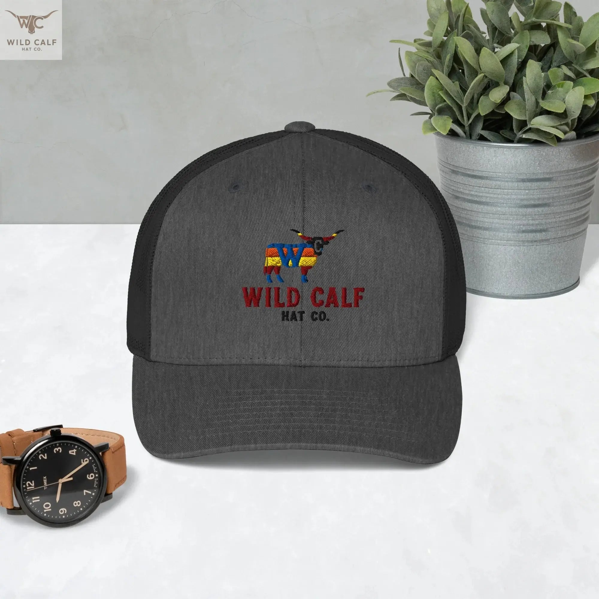 Western dark heather gray retro trucker hat with embroidered calf logo, professional setting
